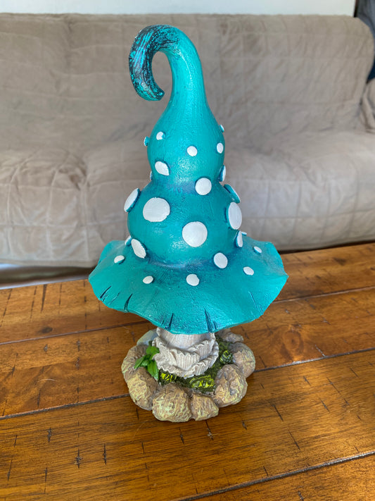 Blue mushroom figure with white spots