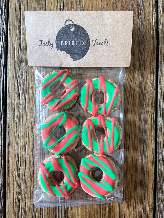 Set of six donut shaped dog biscuits in Christmas colors.